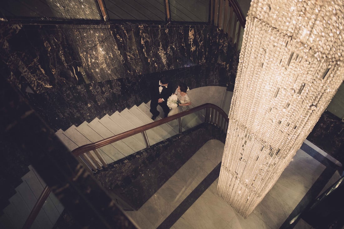 wedding couple on staircase at mandarin oriental, hong kong